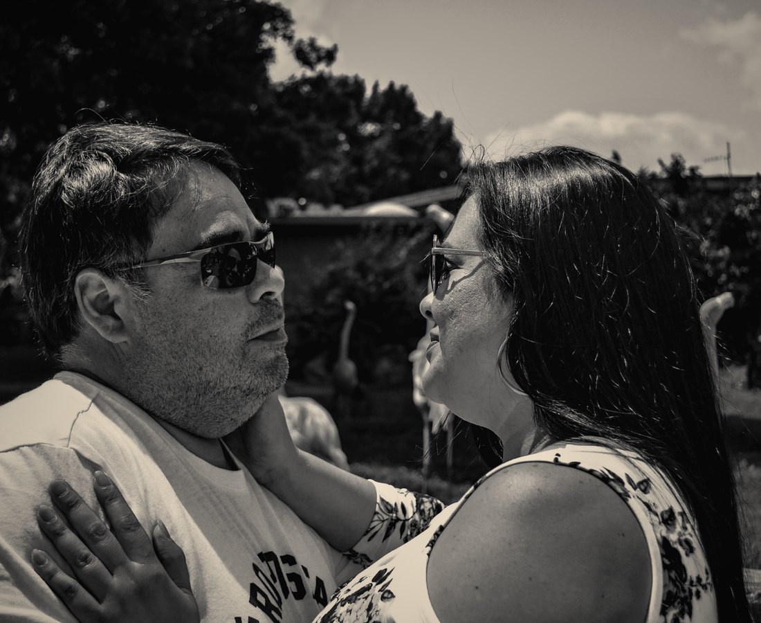 A couple looking at each other outdoors, in black and white