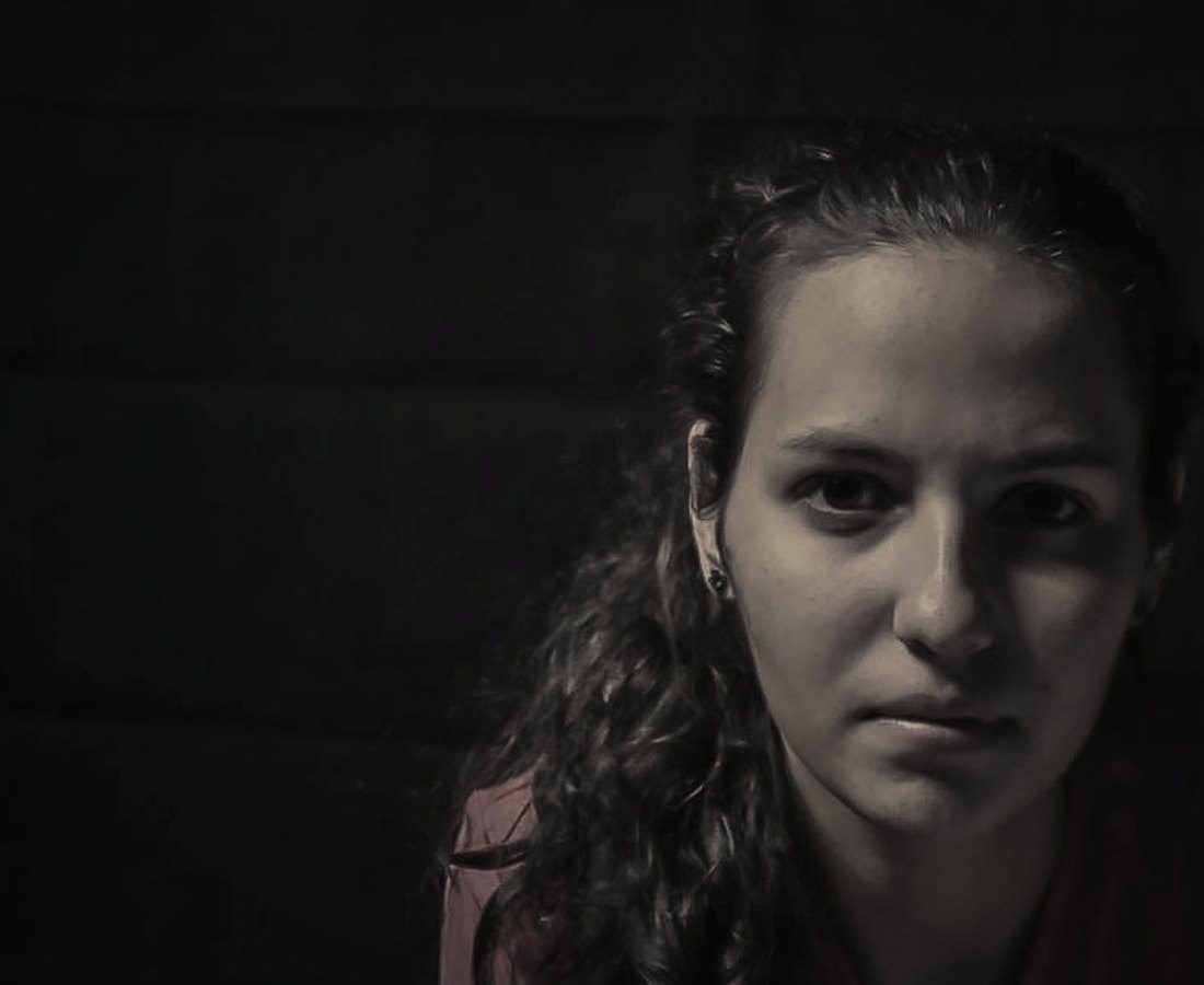 A quiet portrait of a woman lit by a single soft light